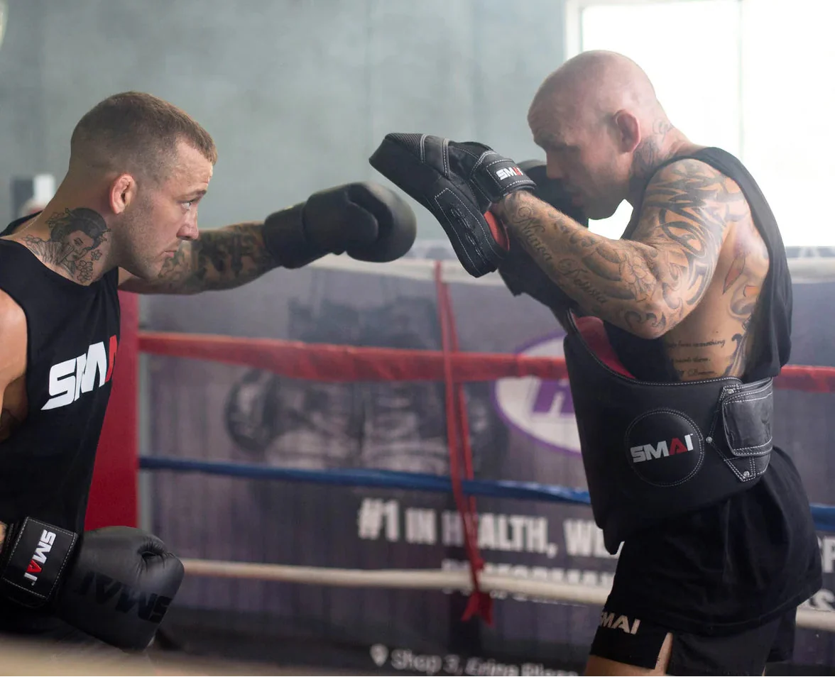 Two men performing boxing exercises